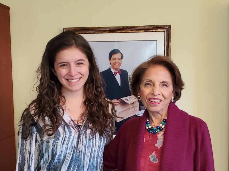 Dr. Sushma Palmer and current Palmer fellow Jessi Silverman pose with a portrait of Mark Palmer